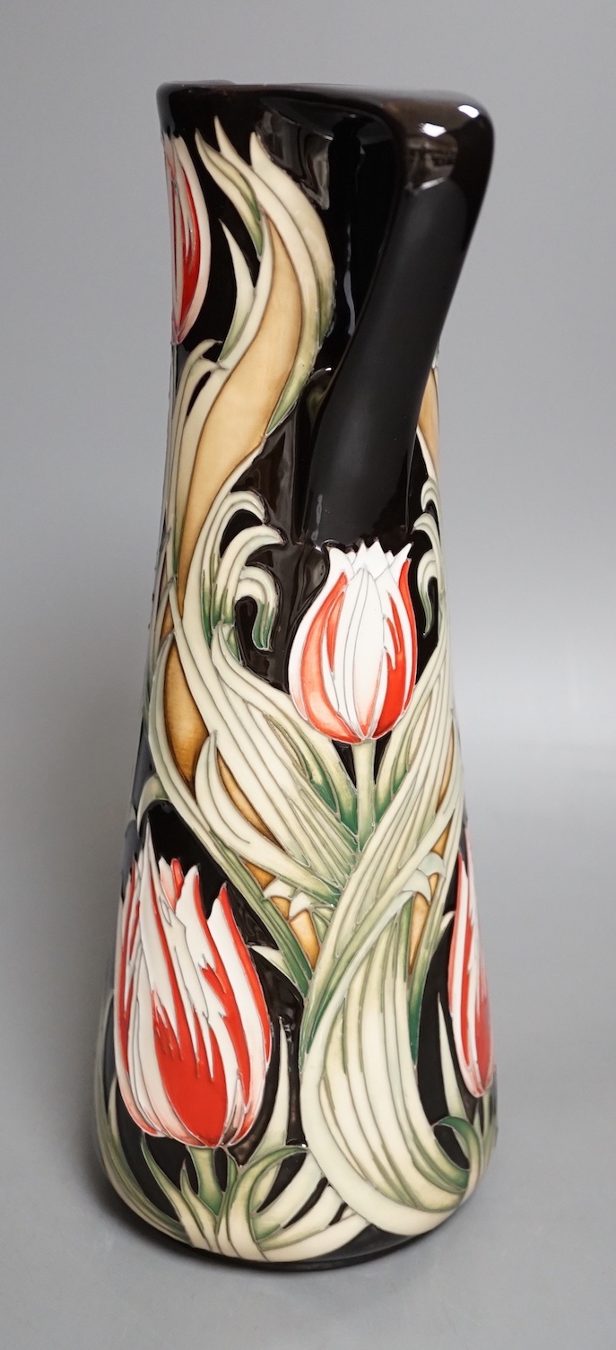 A Moorcroft 'race against time' jug by Paul Hilditch, limited edition 11/40, boxed, 31 cms high.